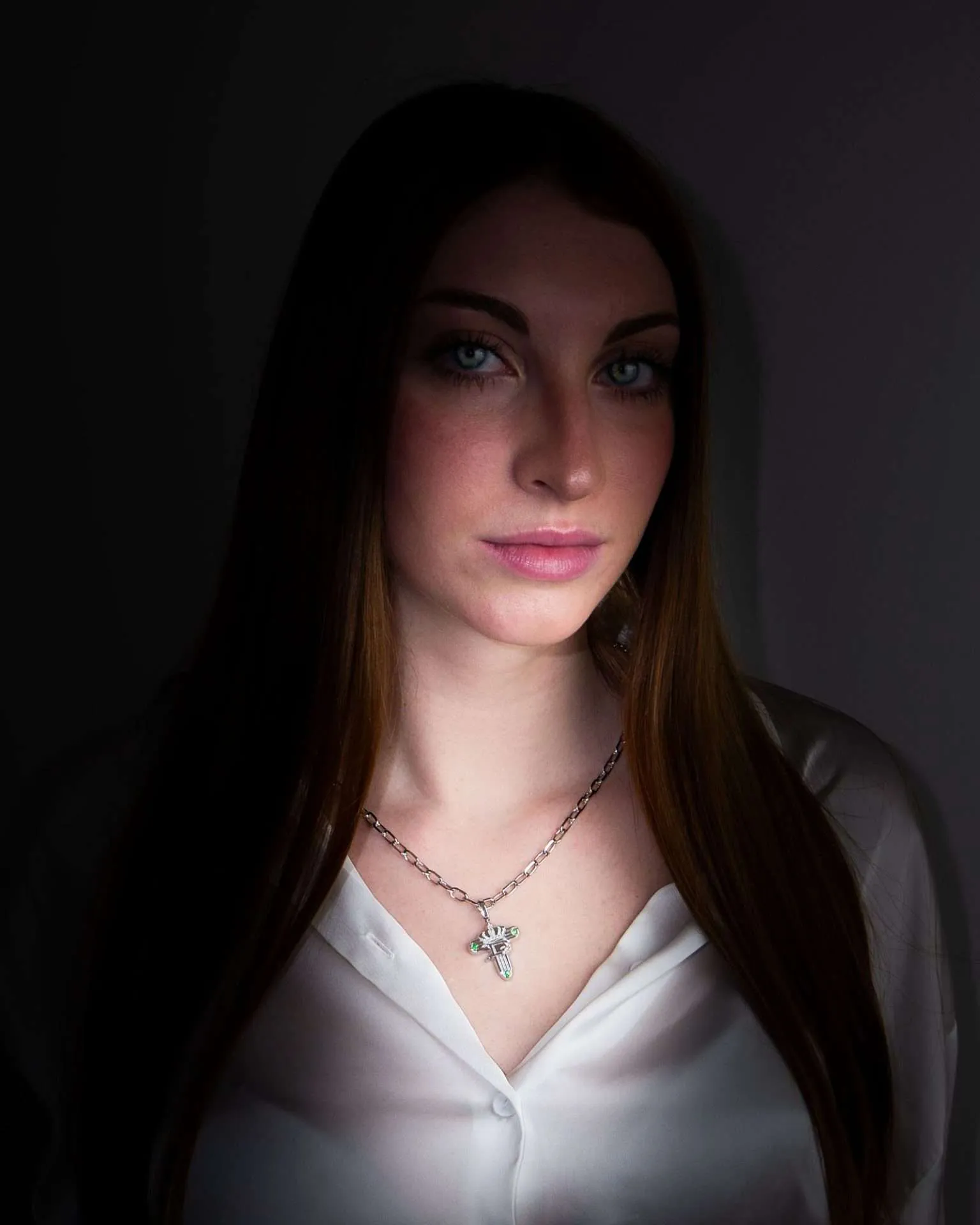 Opera Necklace in white gold, worn by a female model, in shadow