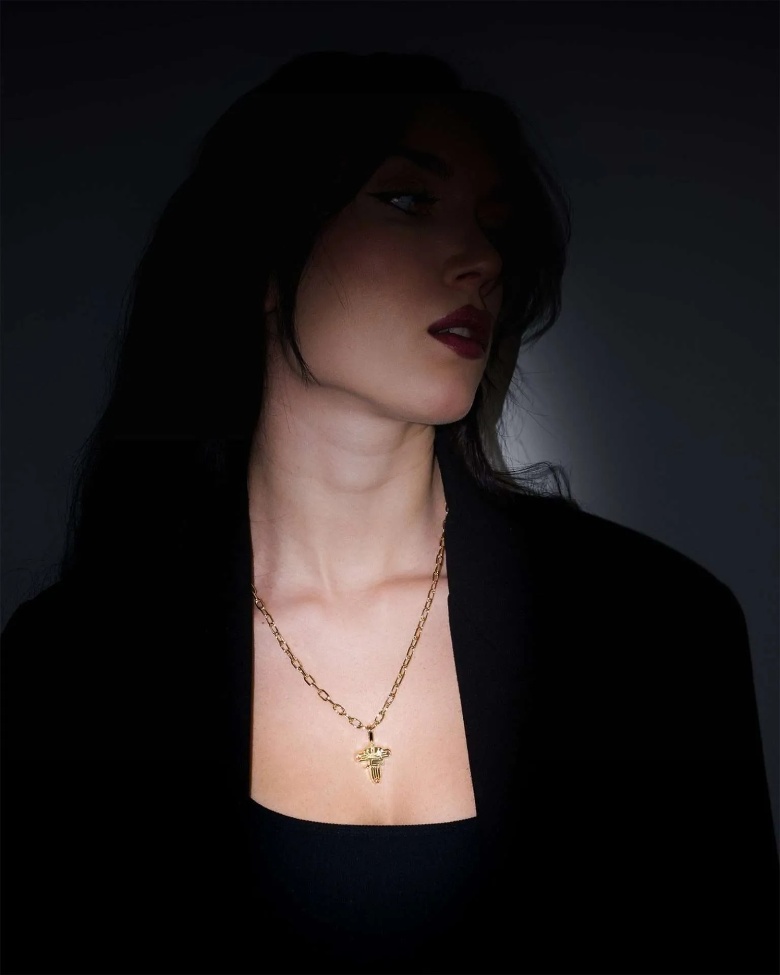 Opera Necklace in yellow gold, worn by a female model, in shadow